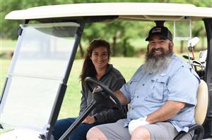 golfers in golf cart